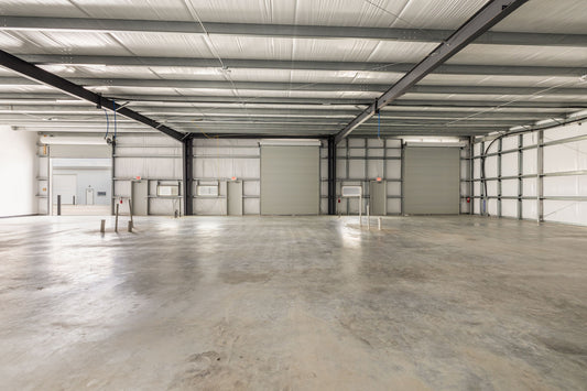 Interior of combined flex warehouse suites showing clear height and multiple roll-up doors at Dacy Business Park